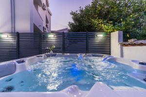 a jacuzzi hot tub in a backyard at Pasko 4 modern furnished ap for 7 in Novalja