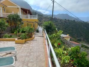 a balcony of a house with a view of a mountain at Orange House in Vallehermoso
