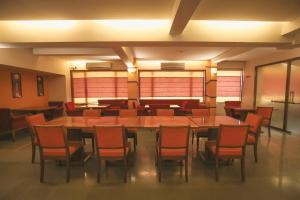 a dining room with a large table and chairs at The Gold Haven in Pune