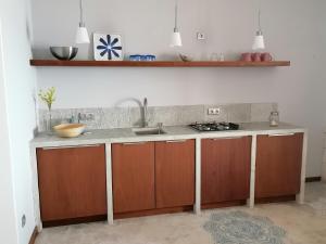 a kitchen with a sink and a counter at Villa Pescadora spectacular view, luxery fisherhouse design in Sal Rei