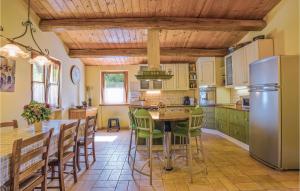 a kitchen with a table and chairs and a refrigerator at Casa Delle Rose in Barchi