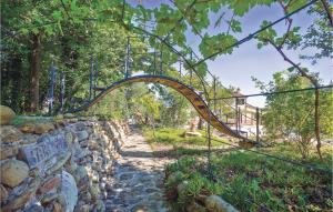 a wooden archway over a stone wall at Casa Delle Rose in Barchi