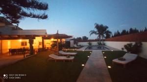 a house with a patio with chairs and a pool at Casa de sueños Benasha con piscina, zona infantil y parking privado in Deltebre
