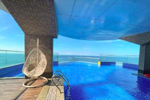 a swimming pool on a building with a view of the ocean at Mermaid Seaside Hotel in Vung Tau