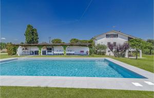 a large swimming pool in front of a house at Villa James in San Costanzo