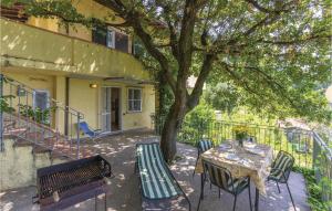 a table and chairs next to a tree and a building at Casa Eliana in Carrara