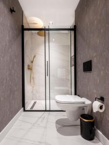 a bathroom with a toilet a sink and a shower at Veyron Hotels & SPA in Istanbul