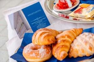 three different types of pastries on a plate on a table at AppartaHotel in Beinasco