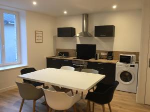 a kitchen with a table and chairs in a room at Gîte Le Relais in Mer