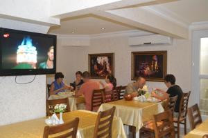 a group of people sitting at tables in a restaurant at New Fatih Hotel in Istanbul