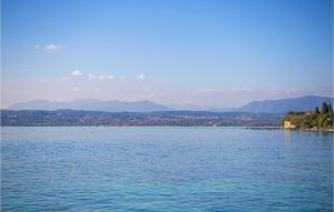 a large body of water with a city in the background at Amazing Apartment In Cavriana in Cavriana +17 photos