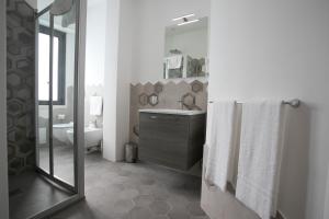 a bathroom with a sink and a toilet and a mirror at Chez Moi Tropea Centro in Tropea +49 photos