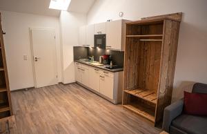 a kitchen with white cabinets and a counter top at Pension Sewald in Berg