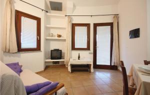 モンテ・ナイにあるStunning Home In Costa Rei -ca- With 3 Bedrooms And Wifiのリビングルーム(ソファ、テレビ、窓付)