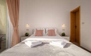 a bedroom with a bed with two towels on it at Studio Apartment Brigita in Mlini