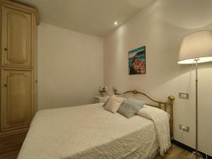 a small bedroom with a bed and a lamp at Rosanna House in Vernazza
