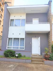 a purple house with a white door and stairs at Juke's Serene Westlands Villa in Nairobi