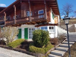 a wooden house with a balcony on top of it at Golfsuite Axel in Uttlau-Haarbach in Haarbach