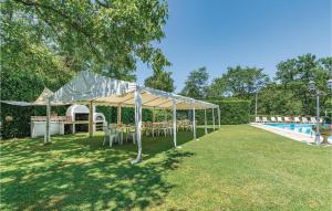 a tent with tables and chairs in a yard next to a pool at Casa Terrossoli in Capolona