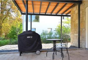 a patio with a table and chairs and a tent at Ferienwohnung stadtnah mit Weinbergblick in Würzburg