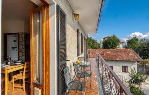 a balcony with a table and chairs on a building at Appartamento Romano in Verbania