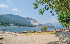 a group of people on a beach near a body of water at Appartamento Romano in Verbania