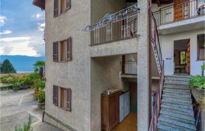 a building with stairs and balconies on the side at Appartamento Romano in Verbania