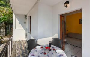 a table and chairs on a balcony with a couch at Appartamento Romano in Verbania +18 photos