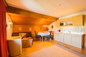 a kitchen with a table and a dining room at Frühstückspension & Appartements Eugenie in Kitzbühel