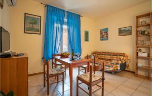 a living room with a table and blue curtains at La Ghiaia in Lido di Camaiore