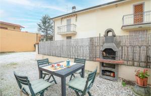 a patio with a table and chairs and a pizza oven at La Ghiaia in Lido di Camaiore