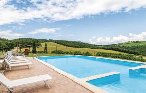 a swimming pool with chairs and a view of the hills at Stunning Home In Acquapendente Vt in Trevinano +23 photos