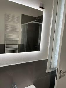 a mirror in a bathroom with a sink at HOUSE RODRIGUEZ in San Lazzaro di Savena