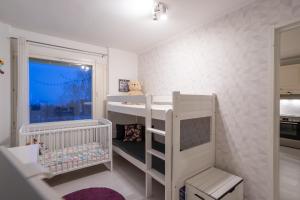 a childs room with a bunk bed and a crib at Modern design w/balcony, free parking,WiFi & A/C in Lappeenranta