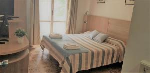 Postel nebo postele na pokoji v ubytování Hotel Enrica