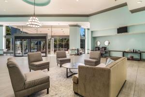 a lobby with couches and chairs and a table at Clarion Inn & Suites in Florence
