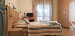Postel nebo postele na pokoji v ubytování Hotel Enrica