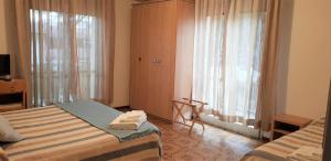 Postel nebo postele na pokoji v ubytování Hotel Enrica