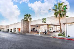 a view of the front of a hotel with palm trees at Quality Inn & Suites Saltillo Eurotel in Saltillo