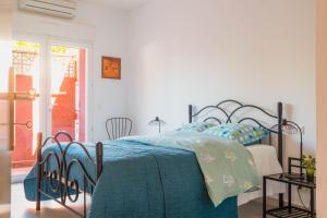 a bedroom with a bed with a blue comforter at Regina's Banyuls - 2 terraces, pool and private parking in Banyuls-sur-Mer +22 photos