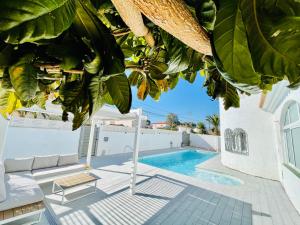 uma villa com uma piscina e uma palmeira em Villa “Castellón“ em Miami Platja