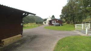 a driveway leading to a house with a white fence at Lamont Chalets in Glenelg