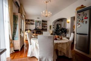 a kitchen and dining room with a table and chairs at A due passi olbia in Olbia