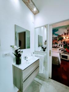 a bathroom with a sink and a mirror at A due passi olbia in Olbia