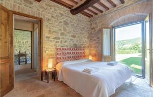 a bedroom with a bed and a large window at Umbriaverde 1 in Valfabbrica