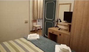 Postel nebo postele na pokoji v ubytování Hotel Enrica