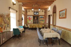 a restaurant with tables and chairs in a room at H Resort Hotel Vagharshapat Armenia in Vagharshapat