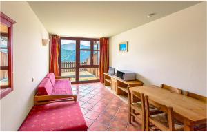 a living room with a red couch and a wooden table at Bilo Stallelunghe 5 in Frabosa Sottana