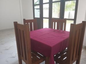 a dining room table with a purple table cloth on it at Horizon Palace - Kabalana in Ahangama +70 photos