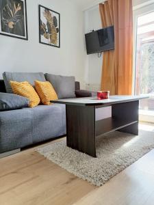 a coffee table in a living room with a couch at Pokoje Gościnne - Za Borem in Zubrzyca Górna